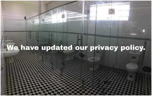 a public restroom with clear glass walls displaying a message about an updated privacy policy