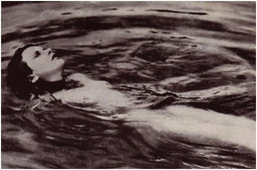 hedy lamarr swimming naked on her back in a forest pond