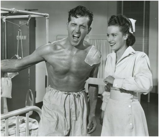 agony for John Payne as cruel nurse Maureen O'Hara gleefully rips the bandages off his torso, along with who knows how much chest hair