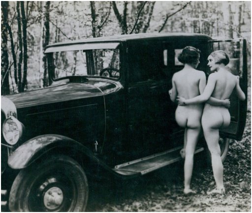 vintage postcard, probably French, showing two nude beauties getting into a fancy touring car to make out in the privacy of a deep dark quiet forest