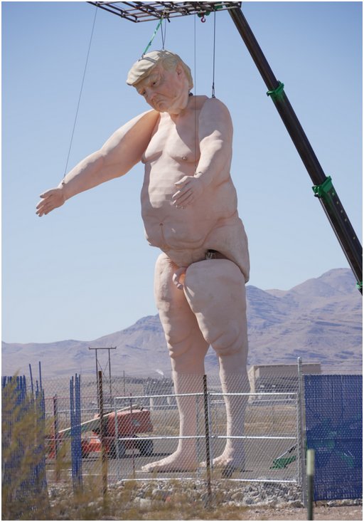 tall forklift installing a giant statue of nude Donald Trump