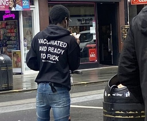 someone wearing a vaccinated and ready to fuck hoodie